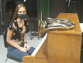 Sophomore Anna Schumacher displays a few of her instruments. The french horn is her band instrument and the piano is the first thing she’s ever played. This is the same piano she used to play at the seventh grade band concert. “Piano is fun. I have most experience with it,” Schumacher said. 