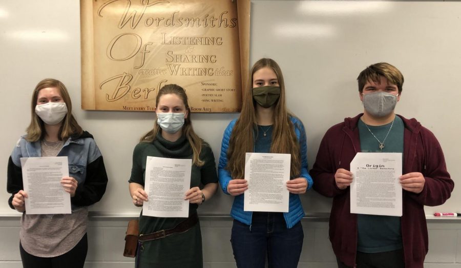 (From left to right) Third place winner  junior Jasmine Rodencal, first place winner junior Regina Schimke, second place winner sophomore Anna Schumacher, and honorable mention sophomore Ethan Brunke, hold up their short stories, after receiving their cash prizes.