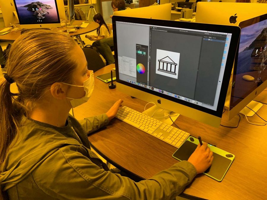Schmitz works on her icon during her second hour Graphic Communications class. To make her icon she used Adobe Illustrator. “My icon represents the social studies department, so Ms. Leahy, Mr. Marquis, Mr. Sotter and Mr. Marshall,” Schmitz said. 