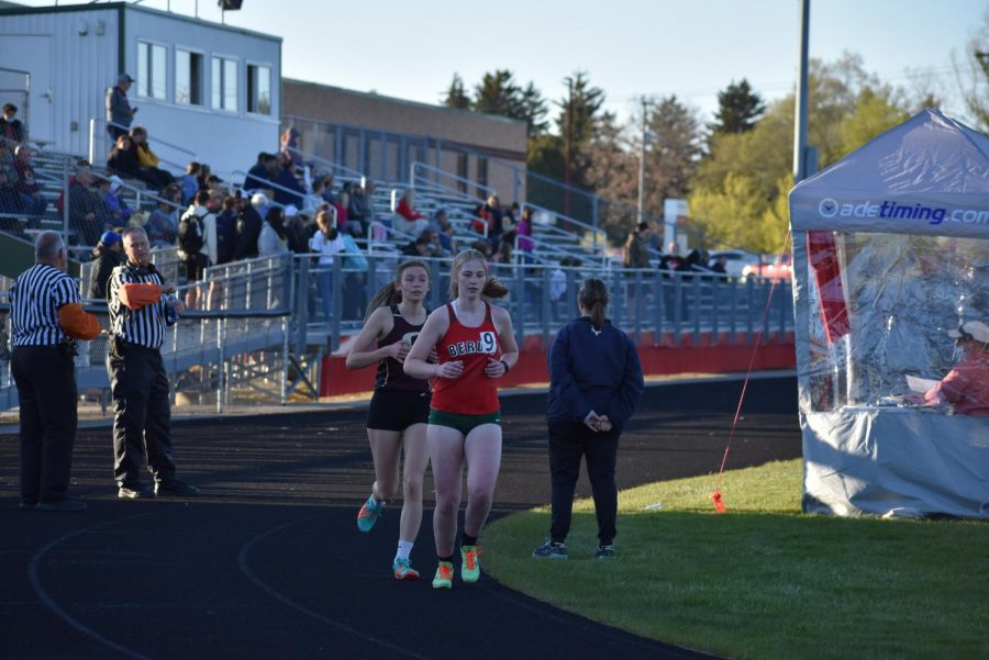 Sophomore Anna Kurczeck keeps a steady pace in front of an Omro runner in the 3200 meter run. Kurczeck placed sixth with a time of 14:22:82. 
