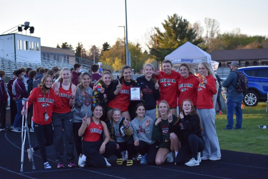 The girls gather around and celebrate their victory after winning first place at the Berlin Invite on April 29.
