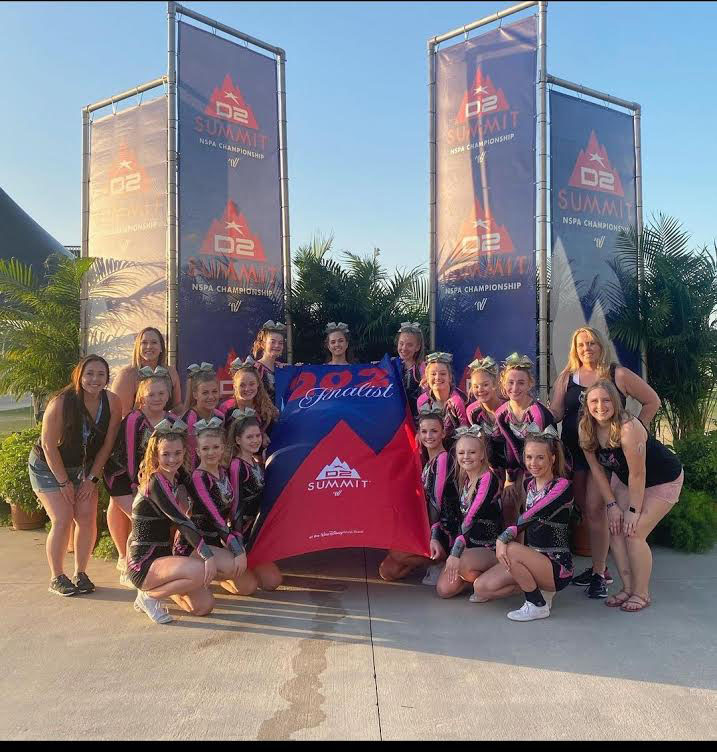 Impact Elite Athletics teams (junior level two, senior level three, and senior level one) are gathered to celebrate their successes by taking a picture. This picture was taken May 15 in the Disney ESPN Wide World Center.