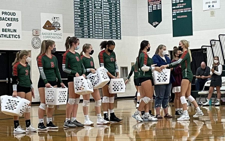 Sophomore+Jane+Hoffman+hands+senior+Violet+Lueck+her+gift+for+senior+night.+The+Indians+lost+to+their+rivals+the+Ripon+Tigers.+I+think+we+do+senior+night+to+give+us+a+chance+to+be+the+center+of+attention.+It+is+our+last+time+playing+the+sport+in+high+school%2C+so+its+nice+to+get+a+night+for+everyone+to+support+and+recognize+the+hardwork+we+put+in+during+the+years%2C+Lueck+said.+