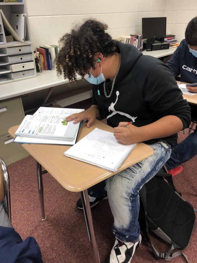 Freshman transfer student Eliel Abreu does his math homework in study hall. He transferred here from Oshkosh North, says his favorite thing about BHS so far is the smaller classes. 

                          
