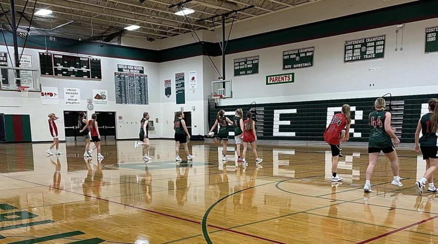 The+girls+varsity+basketball+team+warms+up+for+their+final+practice+before+the+official+start+of+the+season.+The+team+had+a+full+week+of+practice+and+a+weekend+scrimmage+to+prepare+for+their+first+game.+%E2%80%9CThey+just+finished+three+scrimmages+on+Saturday+and+showed+marked+improvement+in+each+and+every+one+of+those+games+which+makes+me+very+optimistic+for+the+season%2C%E2%80%9D+Head+Coach+Carl+Lundin+said.+