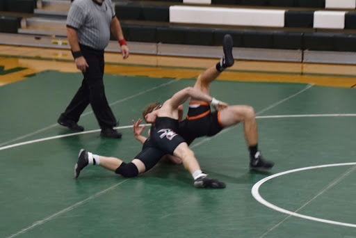 Senior Makade Thom takes down his Ripon opponent.