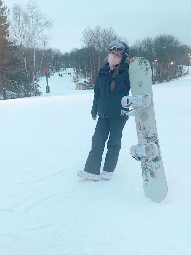 Freshmen Aleea Lichtenberg snowboards at Blackjack Mountain. She, her family, and a friend traveled to Michigan over winter break to have fun snowboarding together.