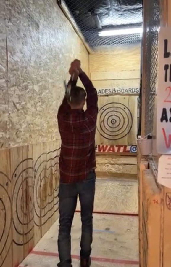 Carter Winter throws axe in attempt to hit the bullseye.