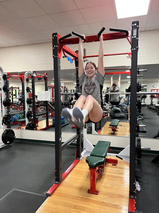 Junior Autumn Young is doing a hanging leg raise at one of the pre-season training sessions for track. “I like to do well and do whatever the coaches teach that will help later,” Young said. 