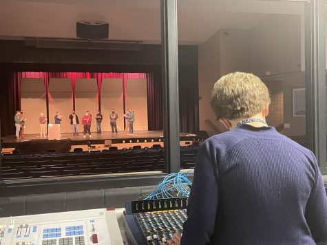 Choir Director Lisa Utecht is fixing how loud the Acovax singers microphones are as they sing “Turn on the Radio,” by Mark Oakley, and “Kaleidoscope Heart,” by Sara Bareilles. Both pieces are class A, and will be performed at Solo & Ensemble.
