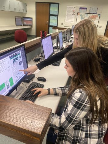 Juniors Emilee Wegner and Anna McCarthy work to format “The Echo” On InDesign. “The Echo” is produced yearly by Juniors on the Red ‘n’ Green. “I enjoy working on this project, it is cool to experience what goes on behind the scenes,” junior Emilee Wegner said.
