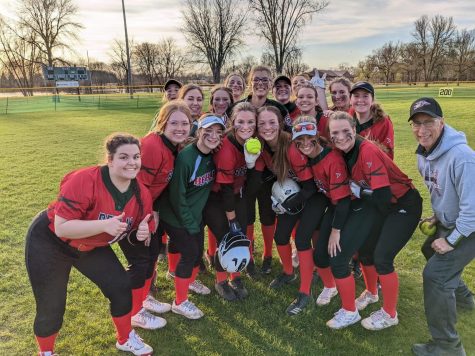 The softball team poses with sophomore Claire Bartols home run ball from their last game against Kewaskum. 