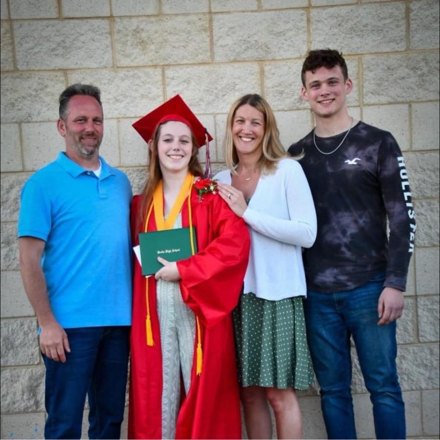 New math teacher Angie Clark poses with her family after the 2022 Berlin High School graduation ceremony.