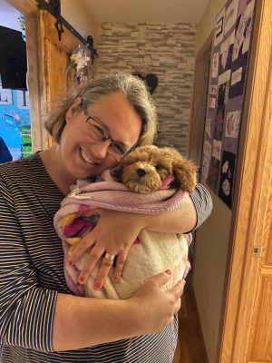 This is a photo of me and our new puppy named Crosby.  He is a Golden Doodle and FULL of energy! new teacher Debra Weiske said.