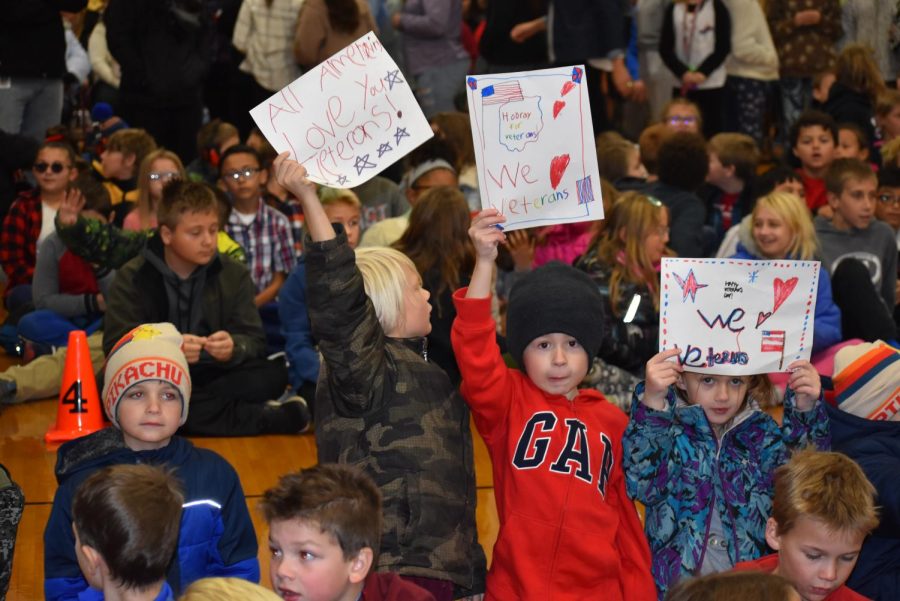 Clay Lamberton Elementary students hold up their signs for the veterans to see. 