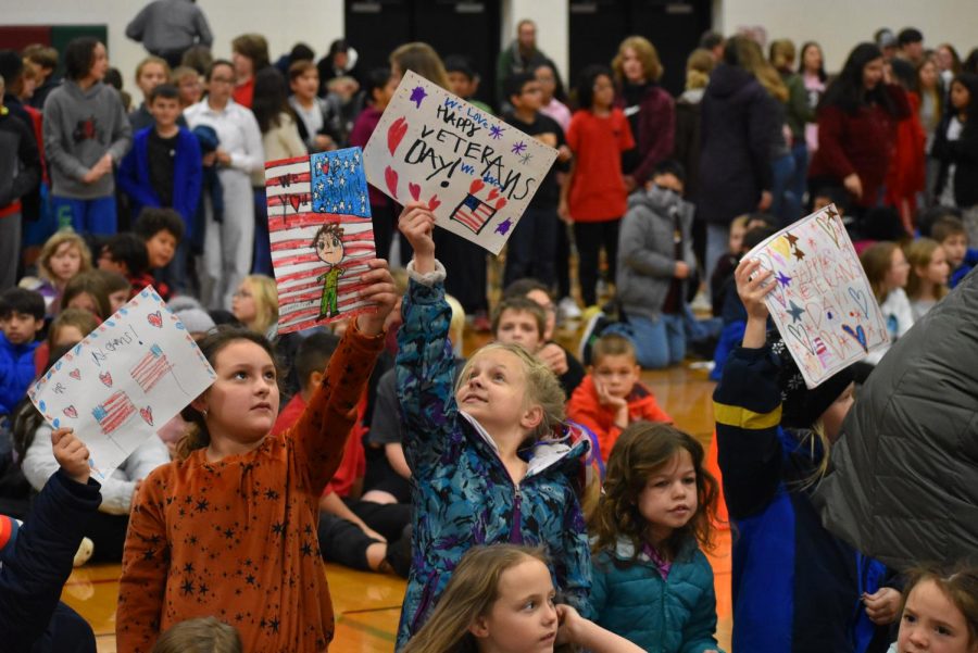 Clay Lamberton Elementary students hold up their signs for the veterans to see. 