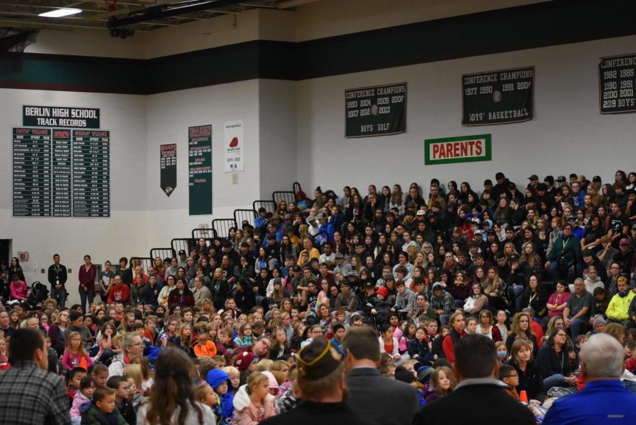 Berlin High School students gather in the bleachers as Clay Lamberton students sat on the floor for the district-wide Veterans Day program.