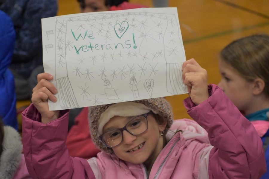 Clay Lamberton Elementary student shows off her poster that she made for the veterans.
