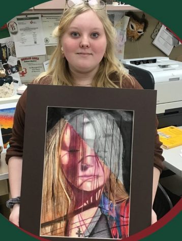 Junior Jenna Tuinstra shows off her work that won the Gold Key award