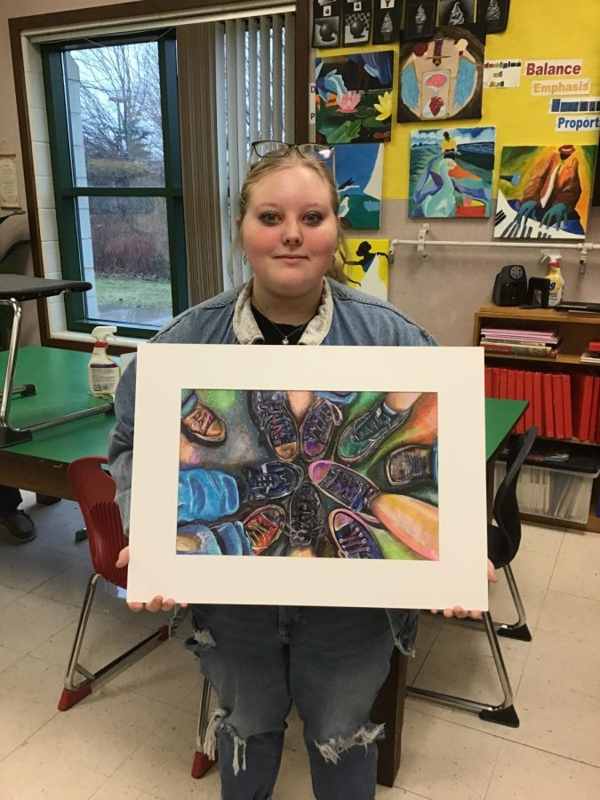 Junior Jenna Tuinstra shows off her work that was recognized  at the state level for Youth Art Month