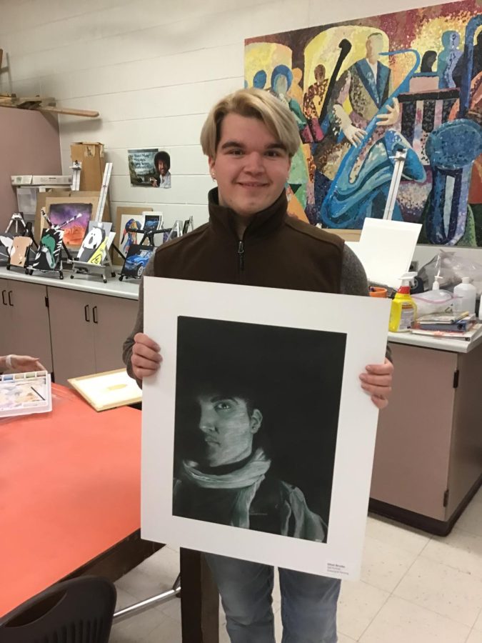 Senior Ethan Brunke shows off his work that was recognized  at the state level for Youth Art Month.
