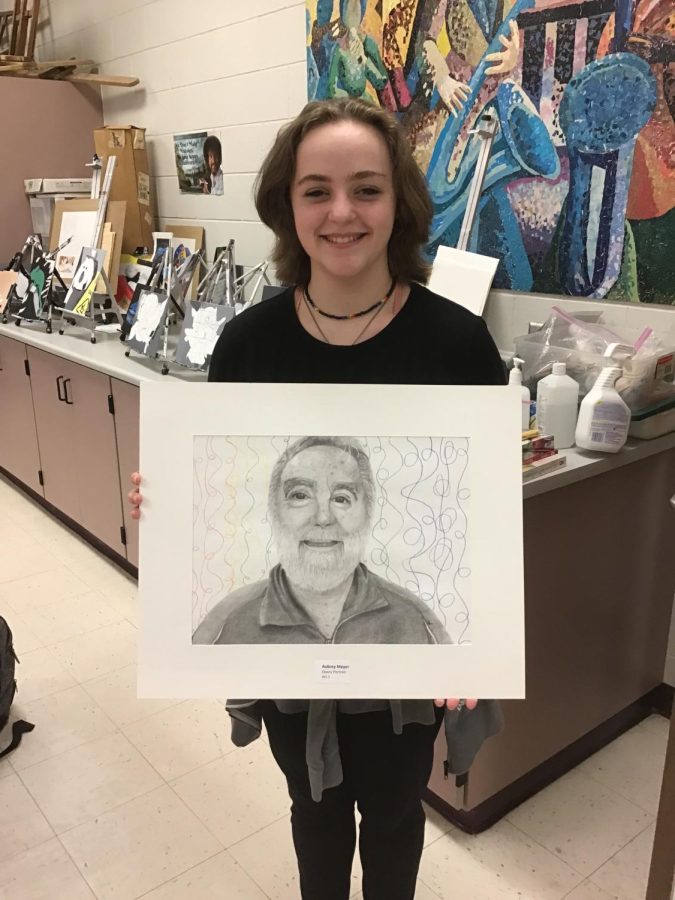 Freshmen Aubrey Meyers shows off her work that was recognized at the regional level for Youth Art Month.