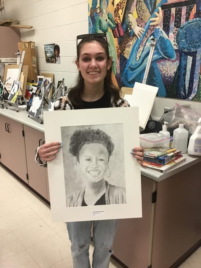 Freshmen Meradeth Reinsbach shows off her work that was recognized  at the state level for Youth Art Month