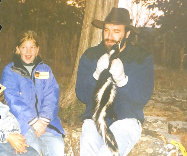 Science teacher Pat Arndt shows students a skunk.
