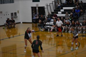 Senior Claire Bartol going for a hit, (Furthest left to right) Jenna Nigbor and Macey Rilling. Bartol has played volleyball since the third grade and is finishing off her senior year strong.
