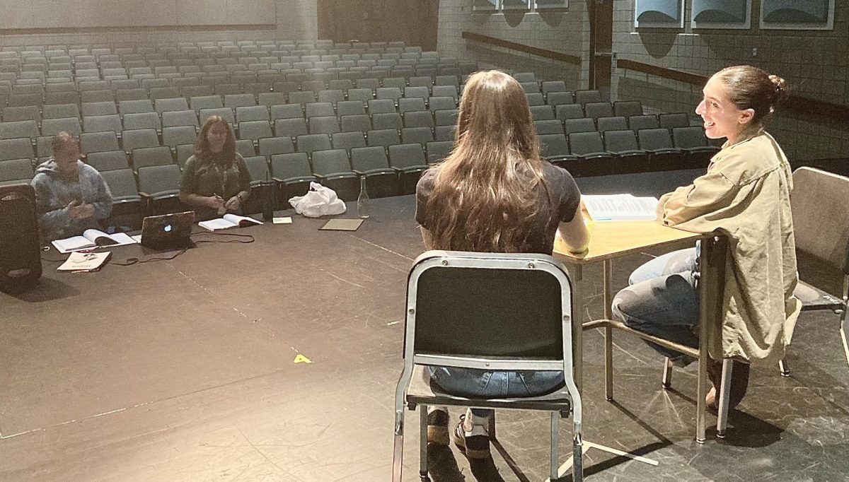 (Right to left) Senior Katherine Femali, senior Mataya Reisleger, music teacher Abbe Lane, and alumna Allie Borland ‘21 run lines at a blocking rehearsal for the upcoming fall production of “Legally Blonde.” “I am in charge of a lot. Besides teaching choir during the day, I also direct the musical, show choir, and our a cappella ensemble, Encore,” Lane said. 
