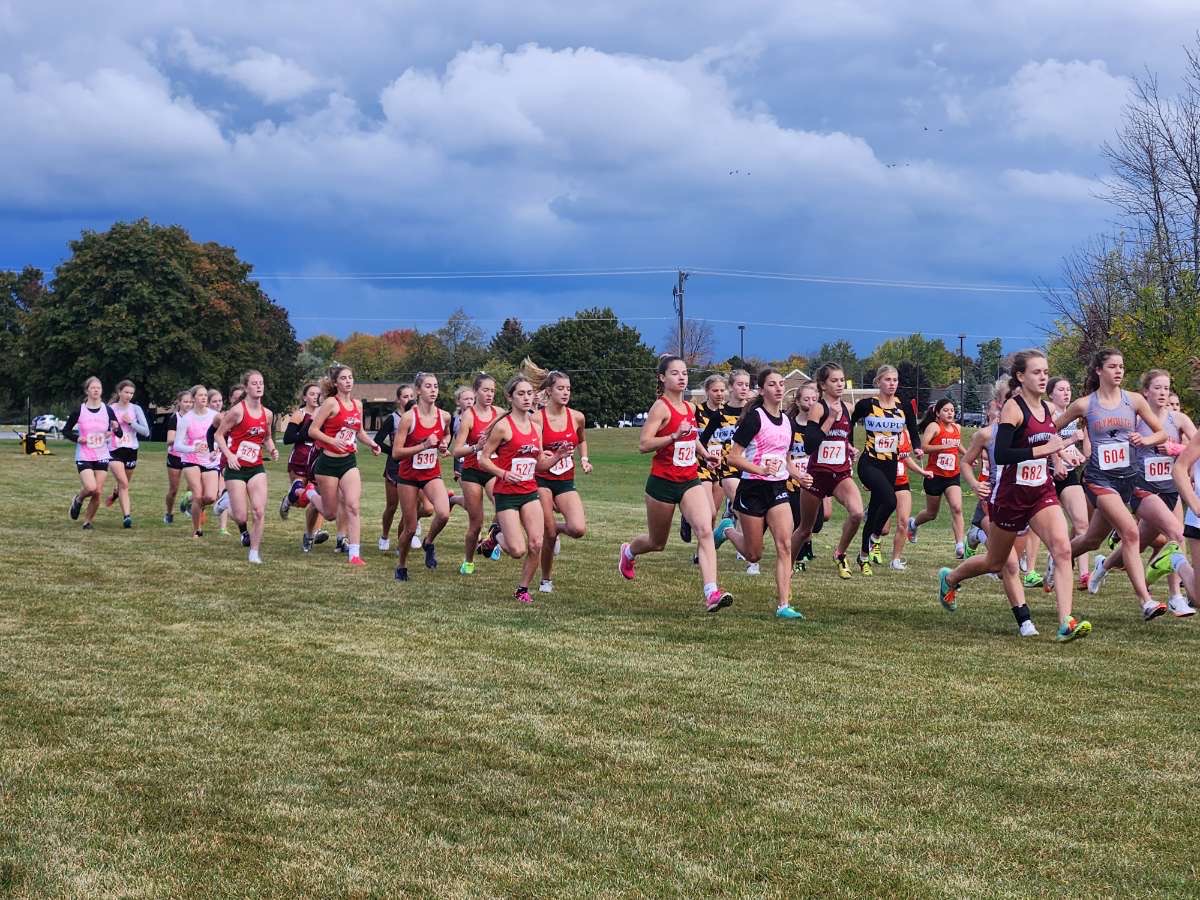The girls cross country team runs in the conference meet at Plymouth on Oct. 14.