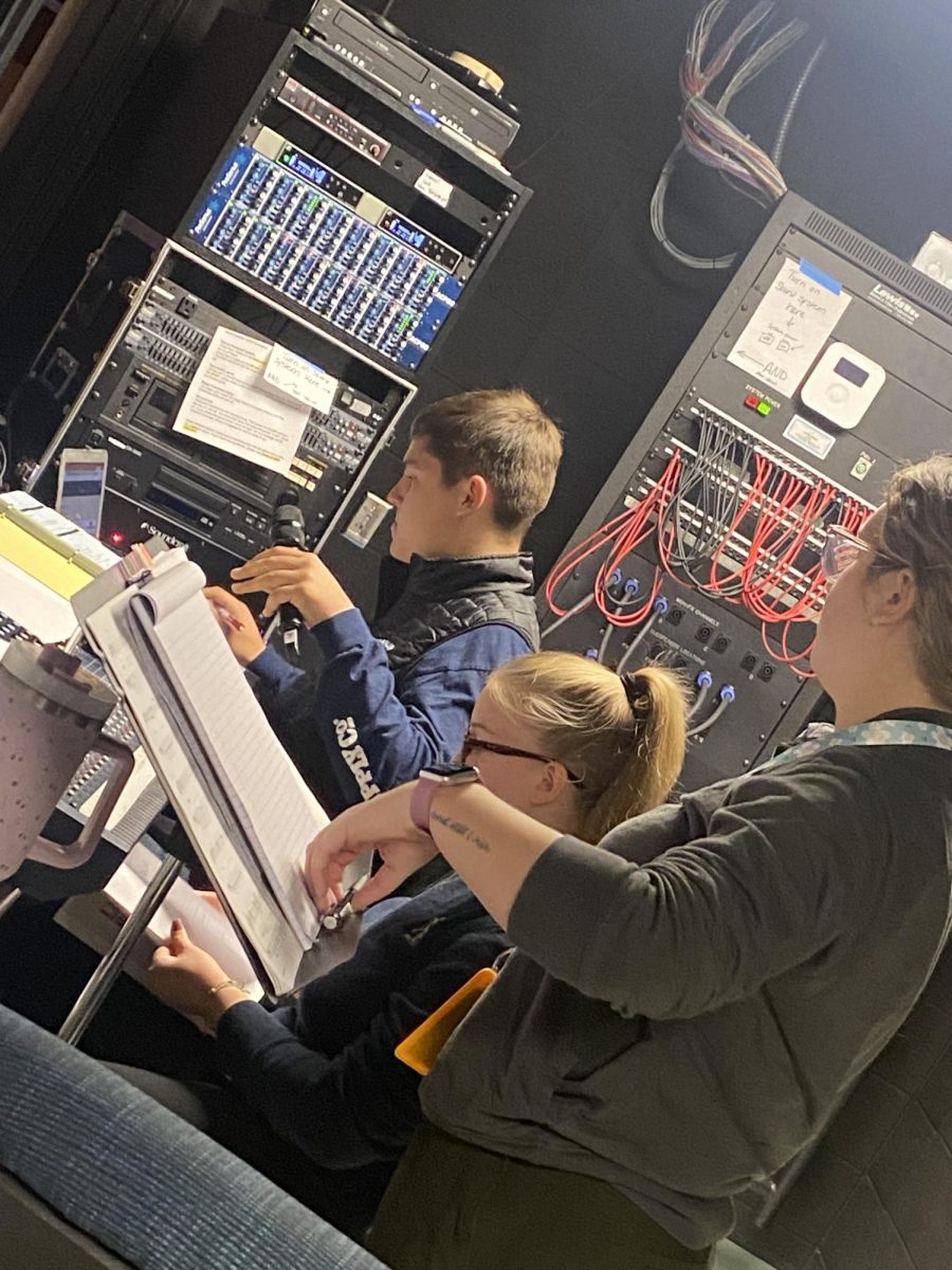 (From left to right) Senior Layten Sobieski, alumna Allie Borland ‘21, and musical director Abbe Lane run sound cues and lights for the musical. “The people onstage are the actors, and the people backstage take care of scene changes…sound effects, microphones, lighting, spotlights, etc.,” Lane said.
