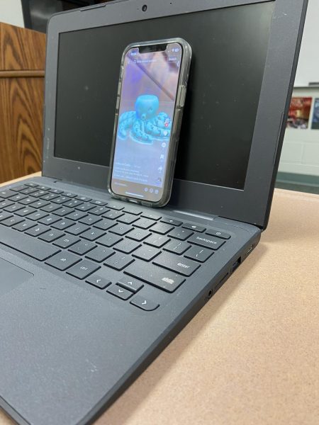 Students use their computers to hide their cell phones during class. It can be very distracting to students and not very useful because most teachers know what the students are doing. 
