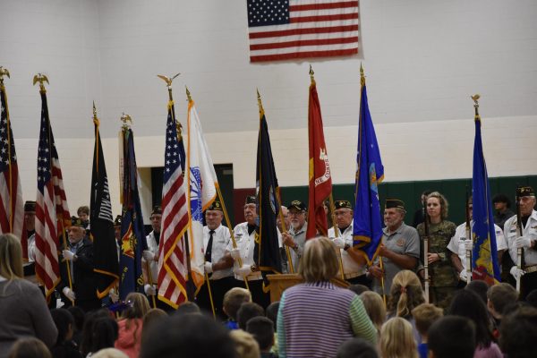 Veterans stand with their different flags after the Presentation of Colors. The high school band played the National Anthem at that time.
