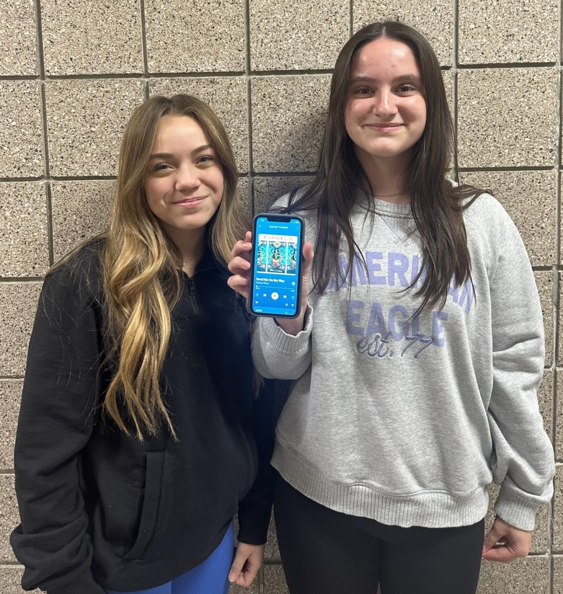 Freshmen Riley Dempsey and Leah Sonnentag listen to Send Me On My Way by Rusted Root. The two have enjoyed listening to this song together since camping up north in the summer.