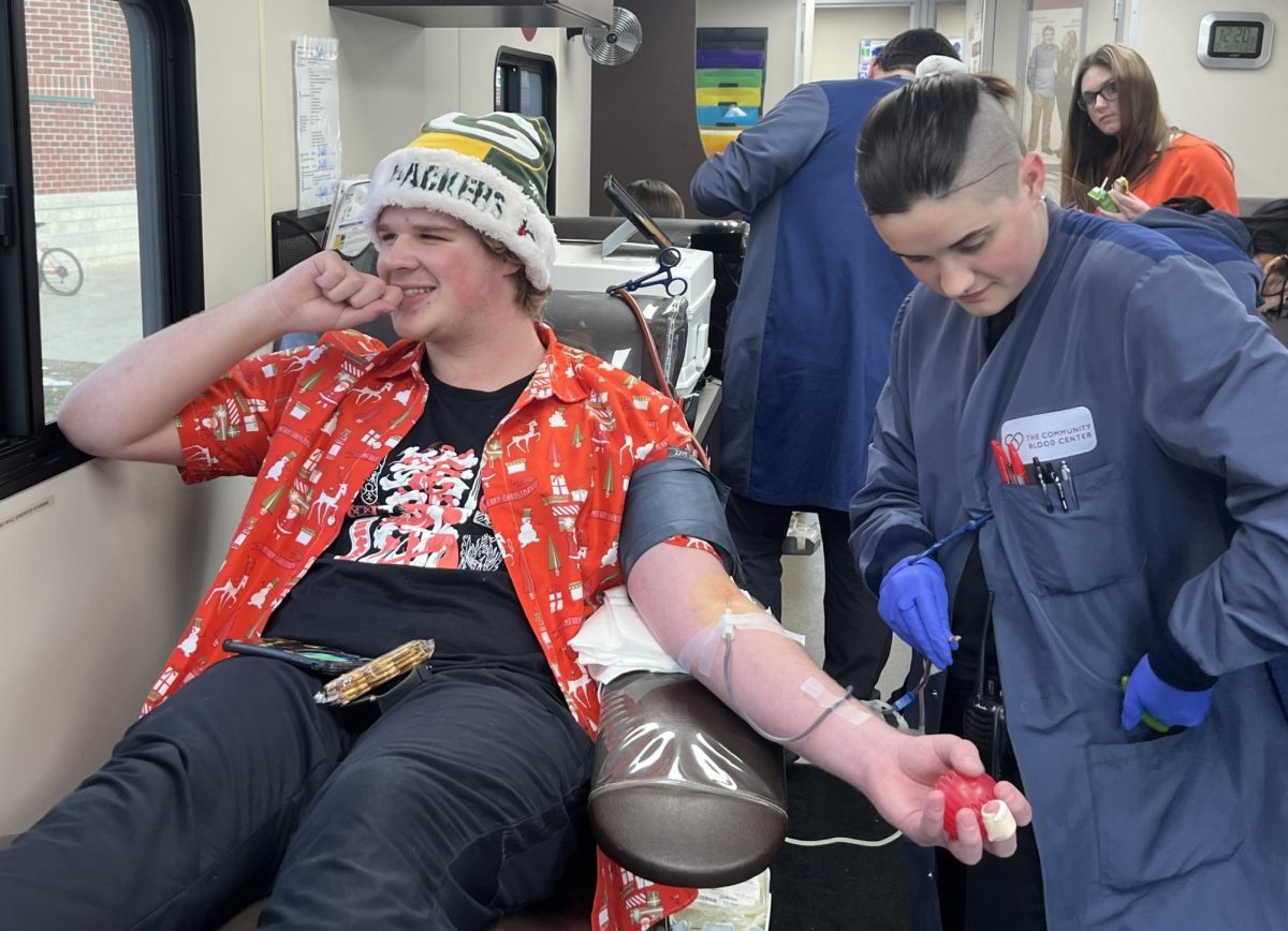 Junior Aidan Pierstorff gives blood on Dec. 15. The blood drive collected 22 pints of blood. “I think that it is a wonderful thing this community does and I’m sure it helps a lot of people,” Pierstorff said. 