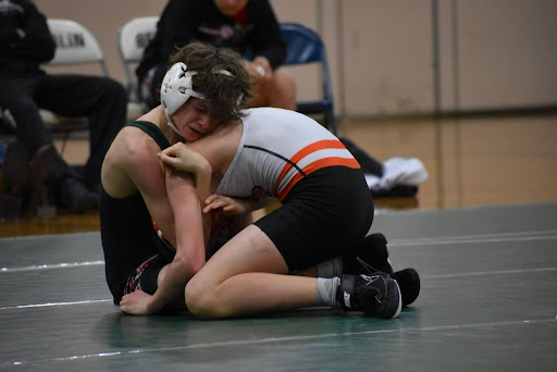 Freshman Gavin Gneiser tries to roll his opponent against Plymouth and pin him at Berlin on Jan. 11.