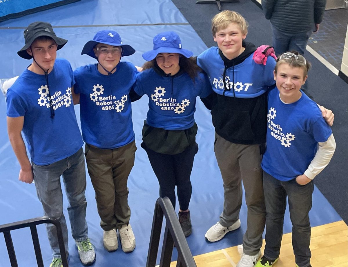 Team Chi and eighth grader Ewan Steffen pose for a group picture after the meet. The team took second place, losing by one point. (L-R: Junior Thomas Schumacher, eighth grader Ben Johnson, junior Kaytlyn Johnson, sophomore James Paskey, and eighth grader Ewan Steffen)