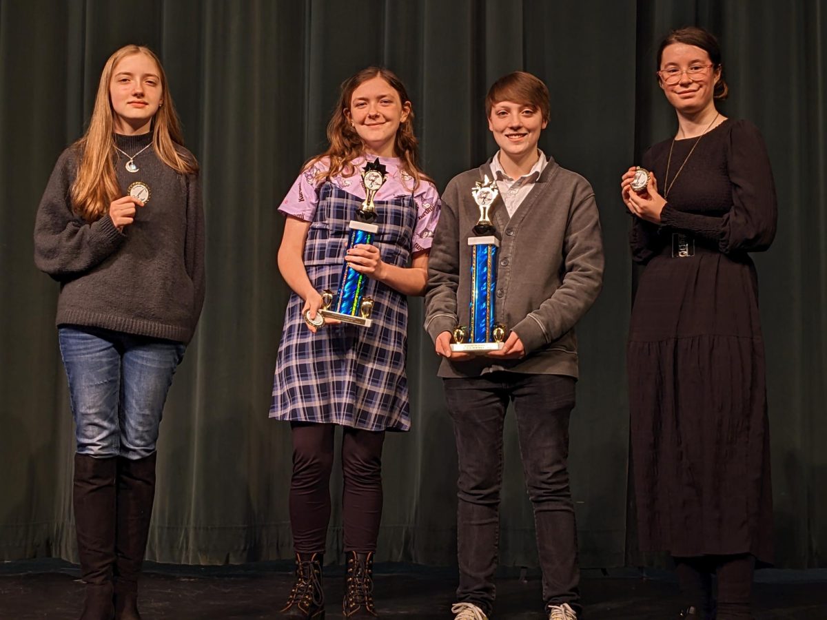 The+four+student+contestants+hold+their+awards.+Junior+Andrew+Rozek+placed+first+with+his+two+poems+entitled+%E2%80%9CFastidious%E2%80%9D+and+%E2%80%9CBeetles%E2%80%9D.+Junior+Arianna+McCormick+placed+second+with+her+two+poems+%E2%80%9CMold%E2%80%9D+and+%E2%80%9CLeaves%E2%80%9D.+%28L-R%3A+sophomore+Emelia+Beulen%2C+junior+Arianna+McCormick%2C+junior+Andrew+Rozek%2C+senior+Violet+Daubner.%29+