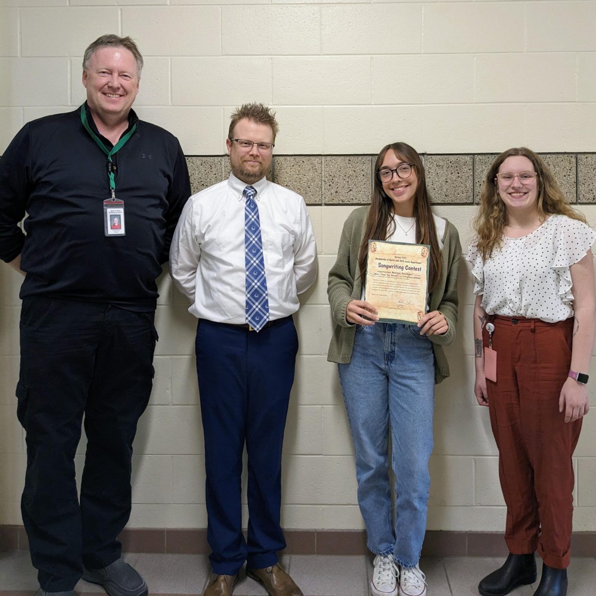Left to right: Wordsmiths adviser Andy Reise, Band Director Ben Ruetten, senior Mataya Raisleger, Choir Director Abbe Lane. Raisleger won the song writing contest, hosted by the wordsmith of Berlin. Her song More Than the World won a $40 prize.