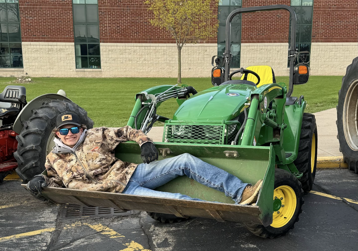 After his 15-minute tractor ride to school sophomore Dierks Martin takes a rest in the scoop. 
