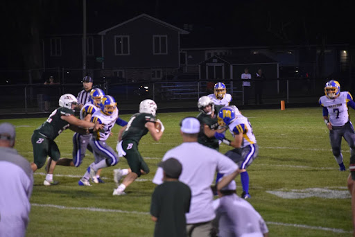 Junior running back Carter Hess runs the ball against Mauston on Homecoming night. 