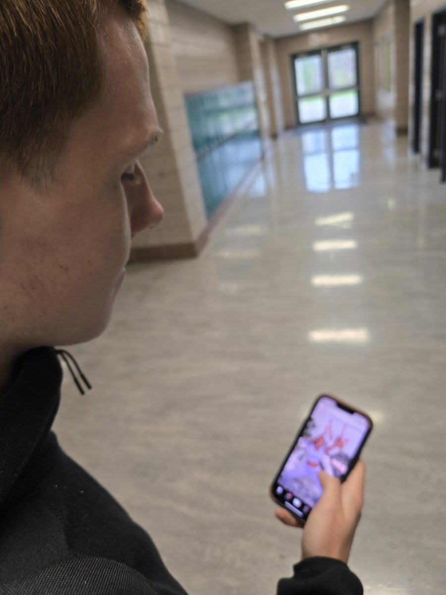 Senior Oliver Maxson watches a dance video on TikTok. Maxson said he spends about 45 minutes a day on TikTok. "I like watching the short-form content. It's easy to watch throughout the day," Maxson said. 