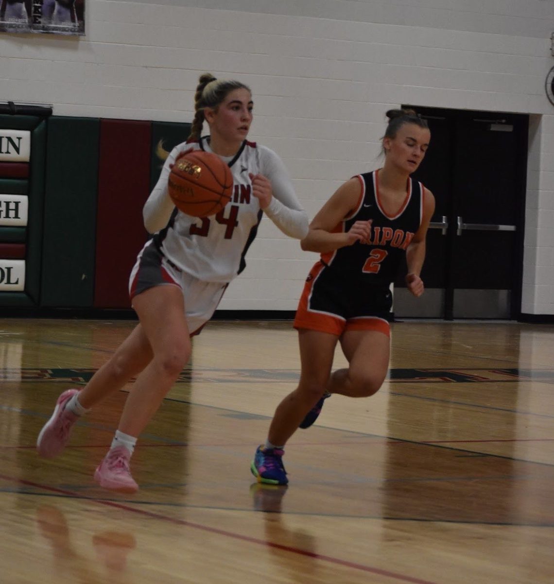 Senior Callie Kurczek runs the ball during the game against Ripon. Kurczek spends her senior year as team captain before she heads to Judson University to play college basketball. “Callie has been a great teammate and captain this year and we'll miss her next year. I hope she does well next year and enjoys playing in college,” junior Becca Bartol said. 