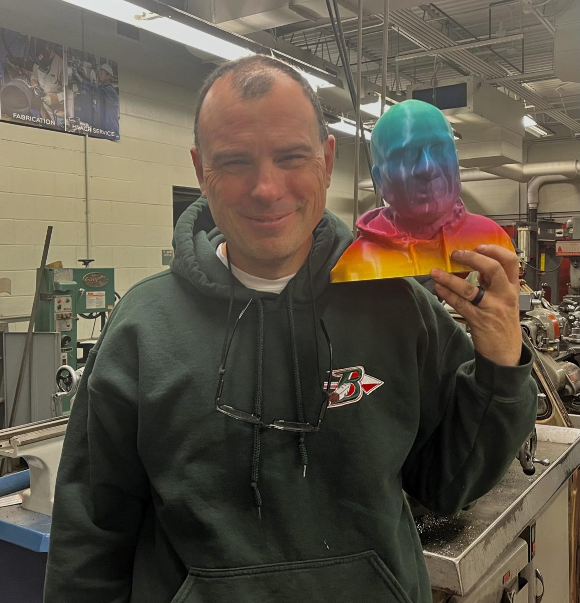 Tech and engineering teacher Bret Steffen poses with his 3D-printed head made by students in an Engineering and Design class.