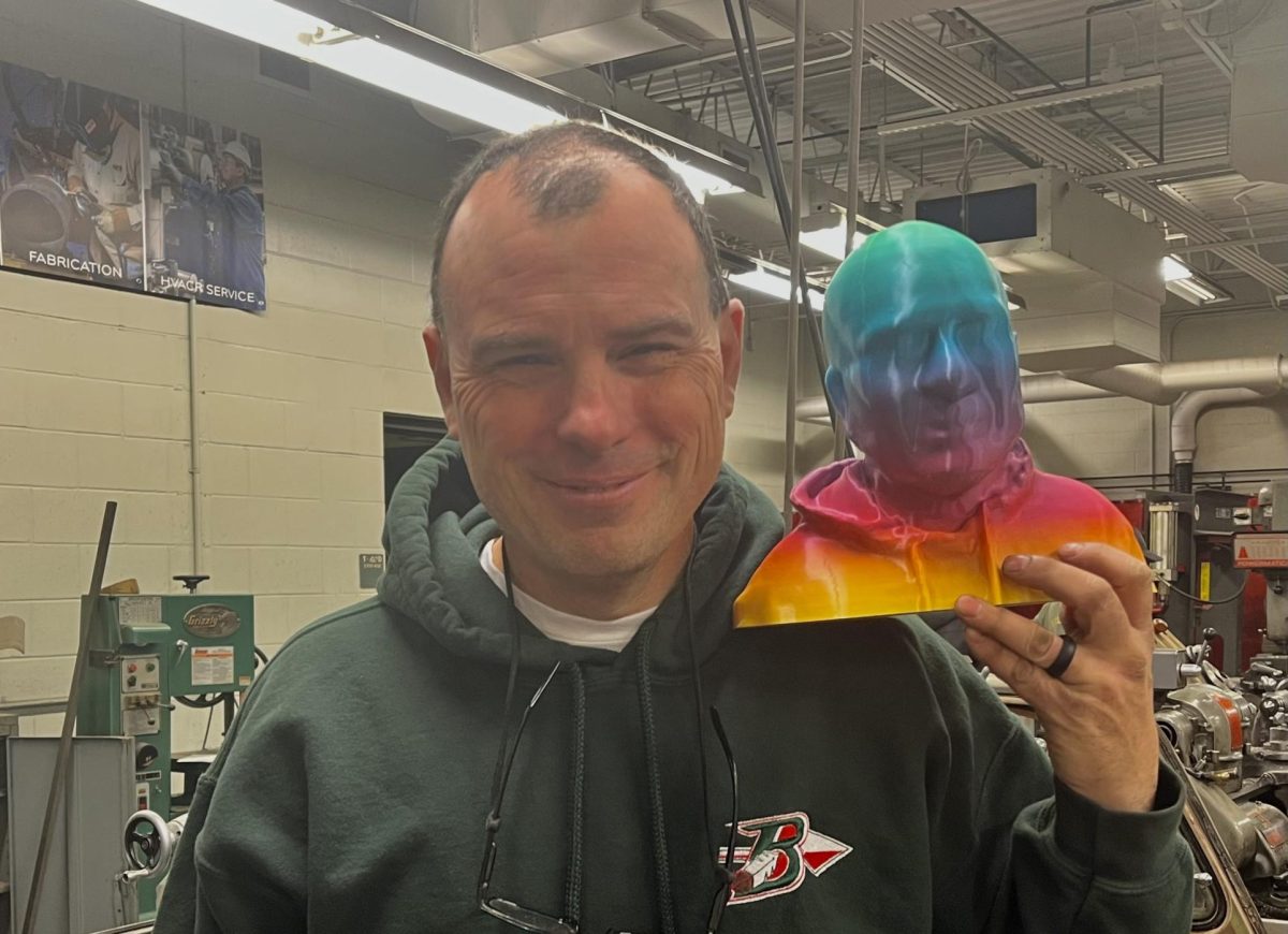 Tech and engineering teacher Bret Steffen poses with his 3D-printed head made by students in an Engineering and Design class.