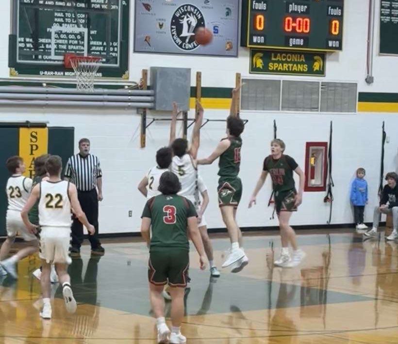 Senior Aaron Bartol makes the 1000th point shot for the first points scored at the game in Laconia High School. 