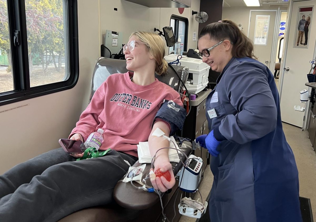 Senior Callie Kurczek gives blood on Feb. 26 during the Key Club blood drive. Only 19 people donated blood during the drive. “The first time is a little nerve-wracking, but after you do it, it’s a good feeling to know that you’re helping people,” Kurczek said.