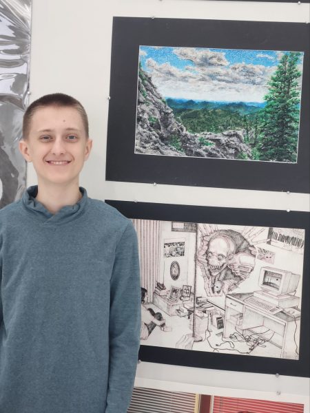 Sophomore Sawyer Hess poses with his painting (top) of the Black Hills in South Dakota. Hess won the Scholastic Golden Key award. “My favorite part was just placing down the dots, it was just fun,” Hess said. 