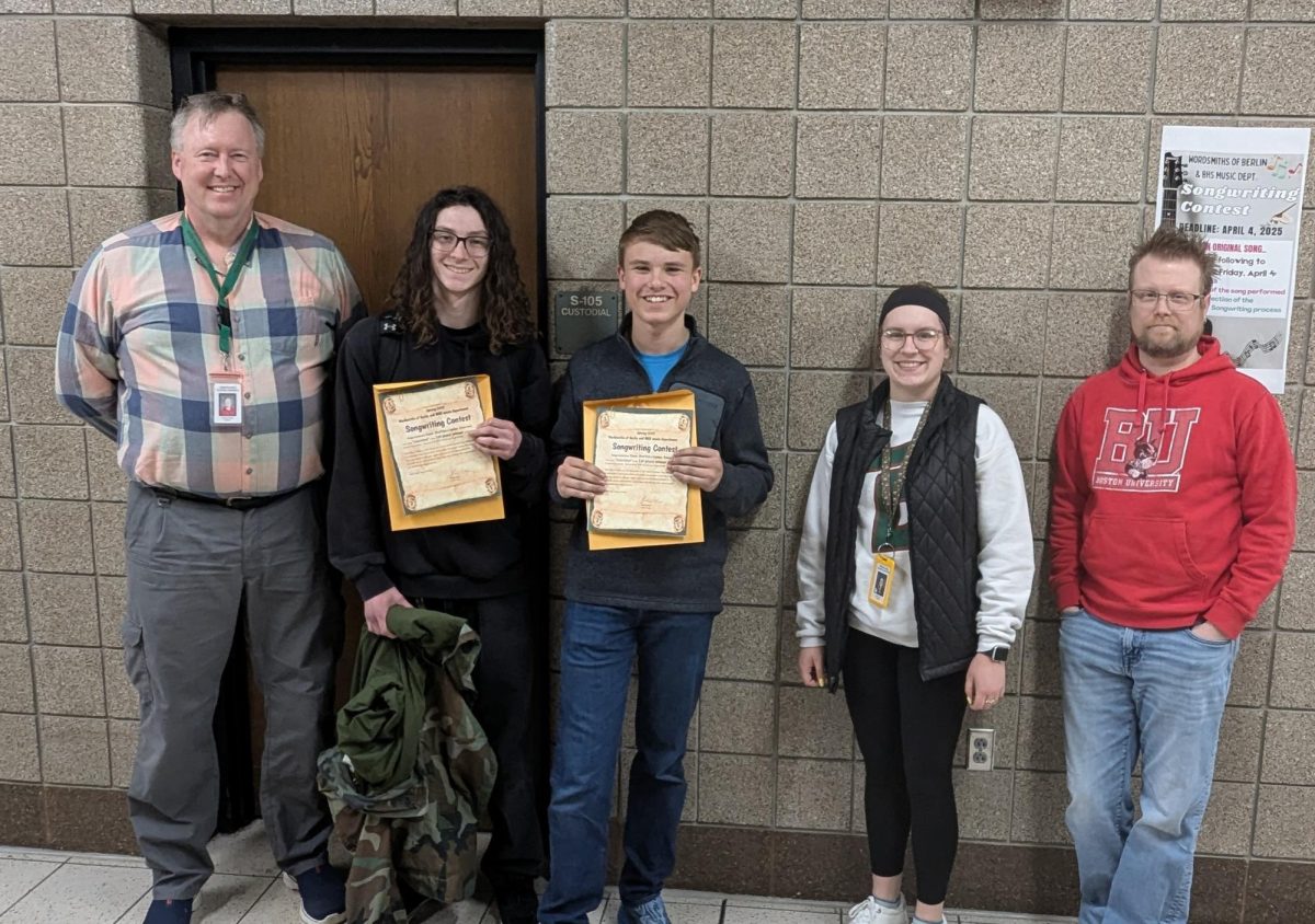 Left to right: Wordsmiths adviser Andrew Reise, freshman Connor Emerson, freshman Ewan Steffen, choir director Abbe Lane, and band director Ben Ruetten. Emerson and Steffen won the songwriting contest, hosted by the Wordsmiths of Berlin, with their entry titled “Colorblind.” Together they won a $45 prize (or $22.50 each). 
